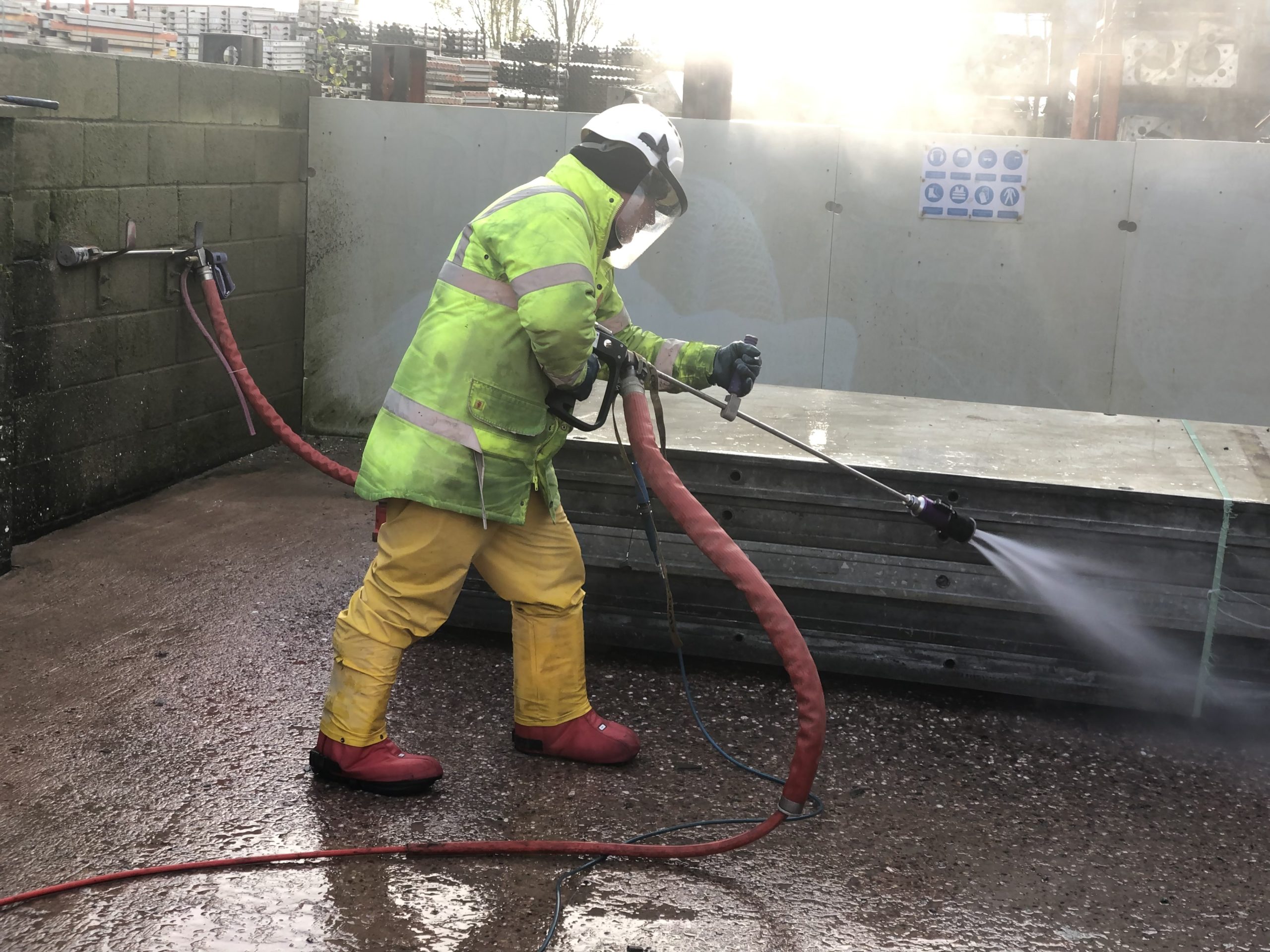 Trainee learning how to clean formwork.