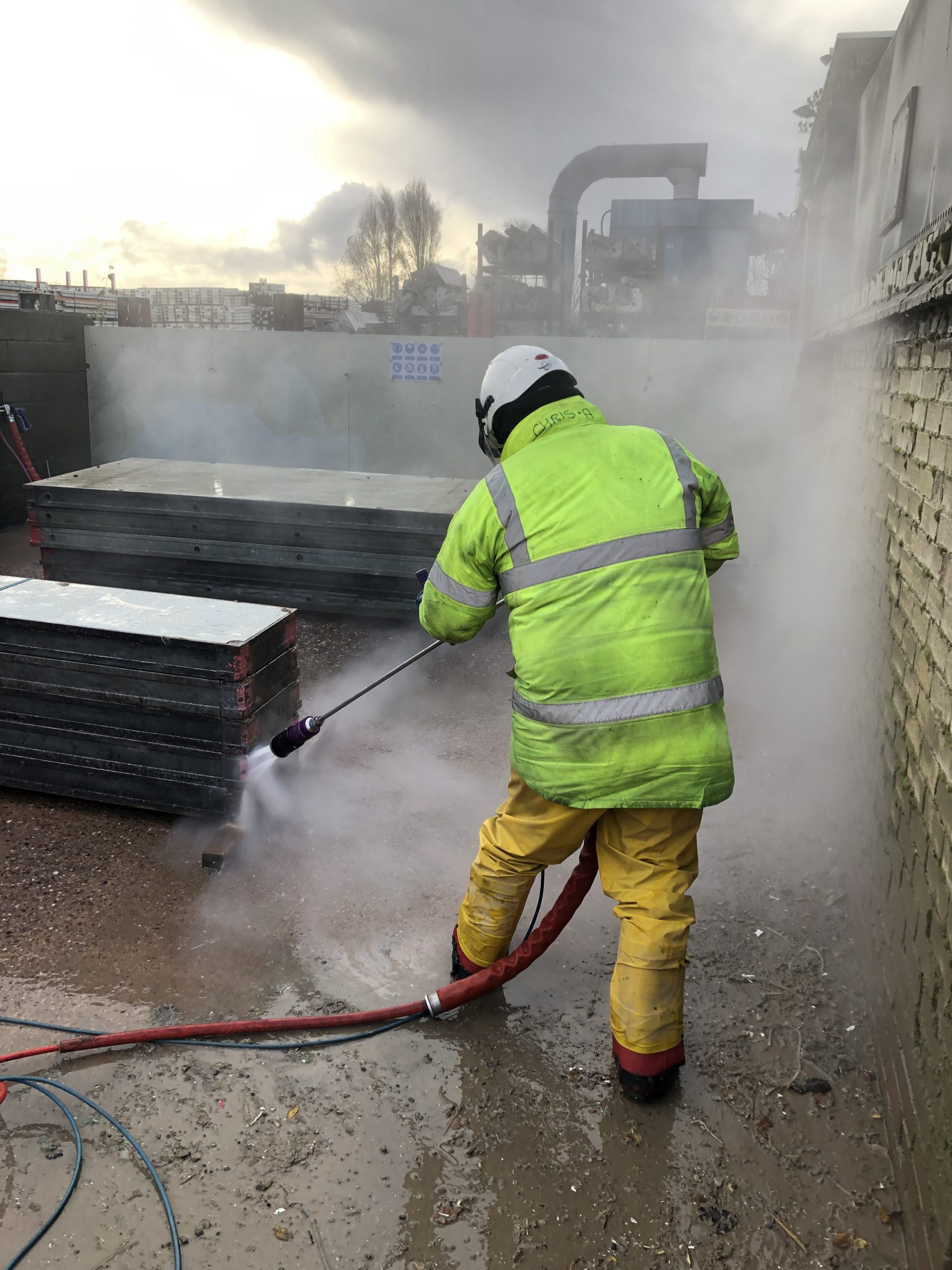 Trainee learning how to clean formwork.