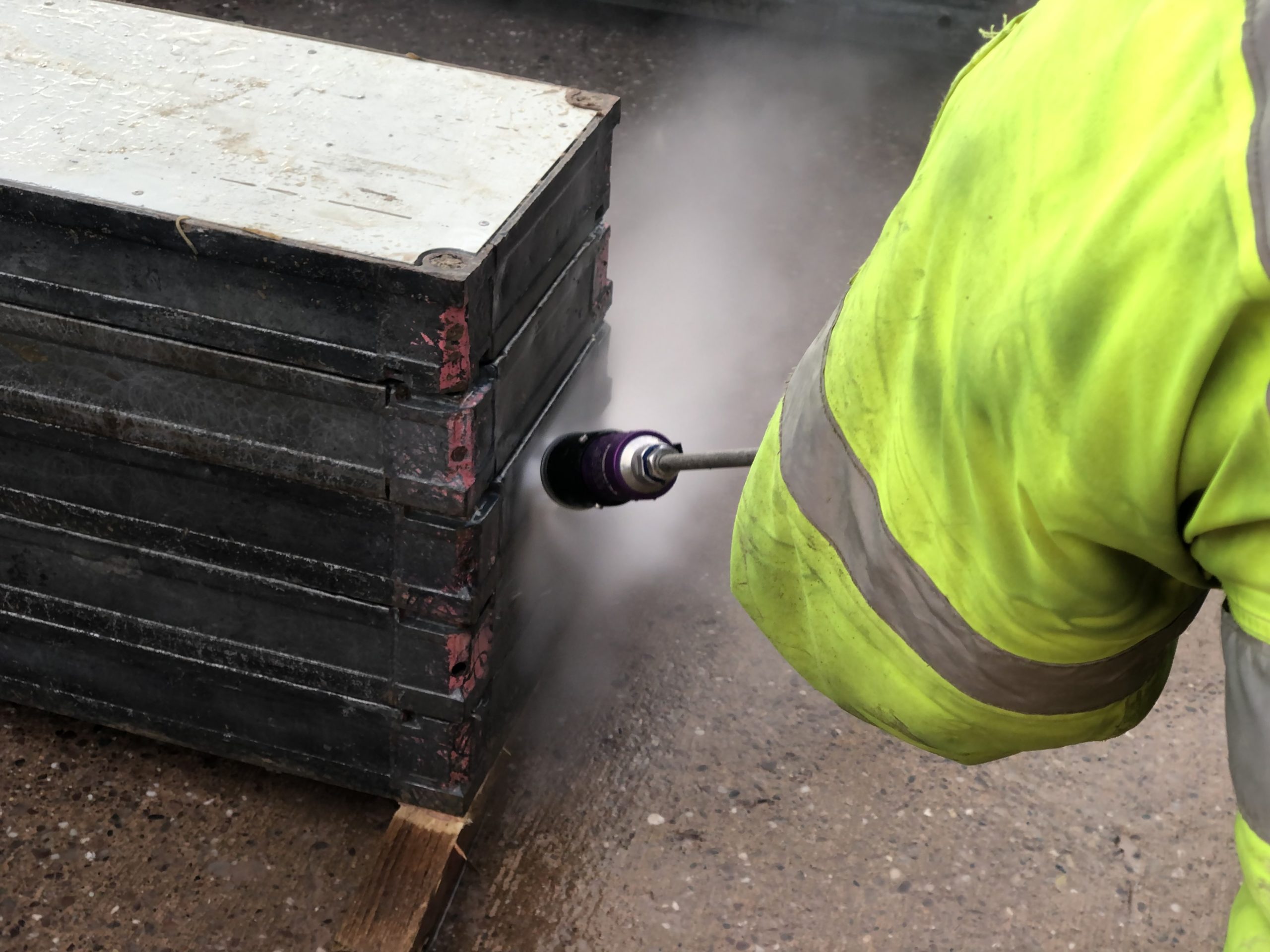 Trainee learning how to clean formwork.